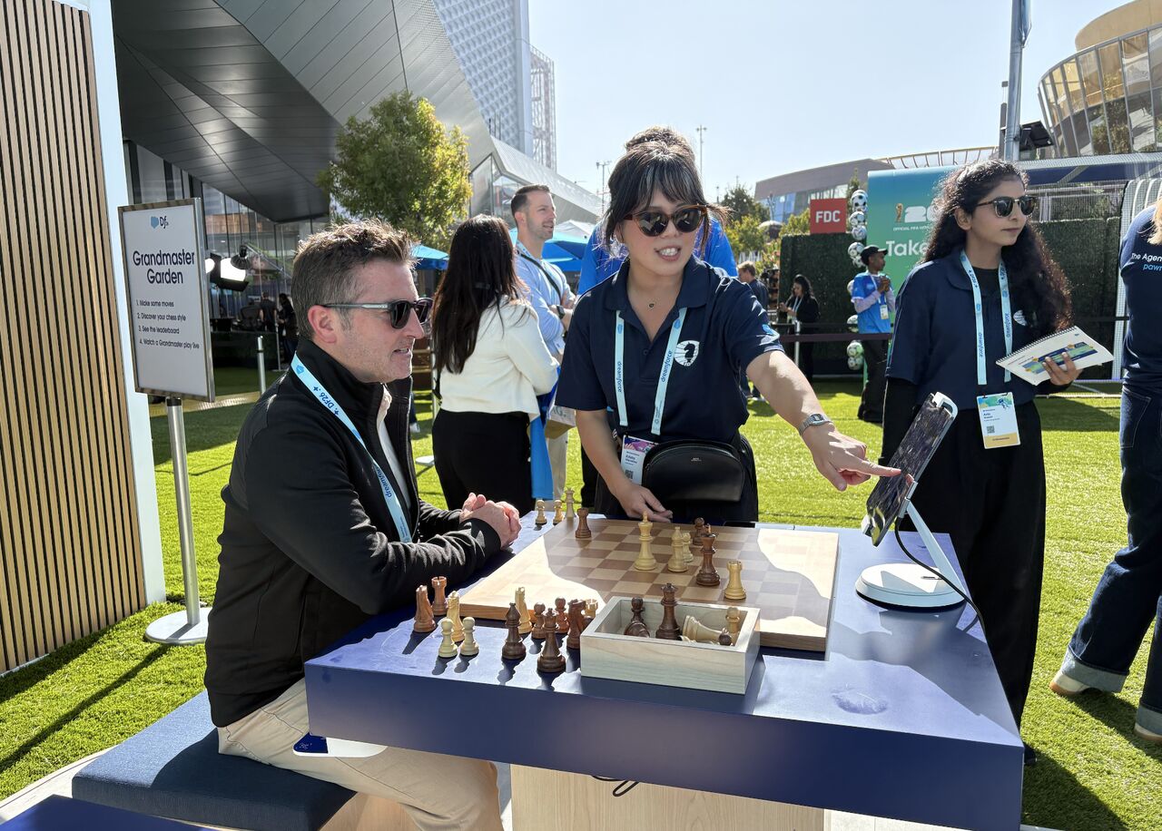 An attendee playing chess at a Grandmaster Garden table